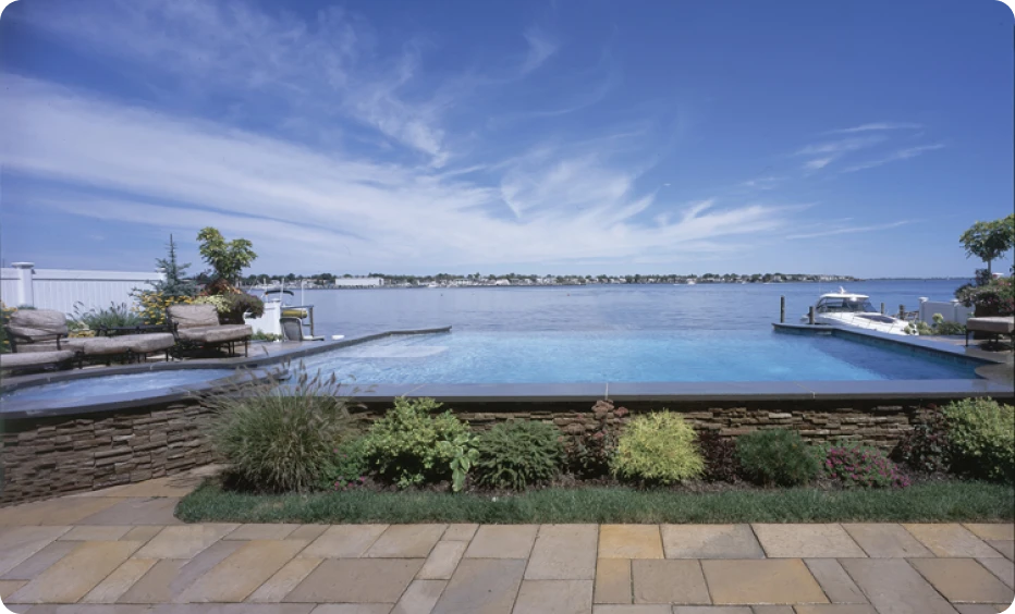 Infinity pool overlooking a serene lake view.
