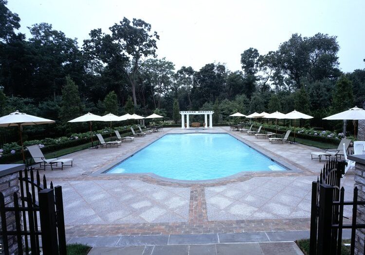 Outdoor pool with lounge chairs and umbrellas
