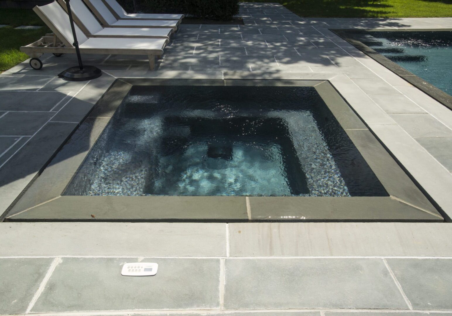 Small square hot tub on patio