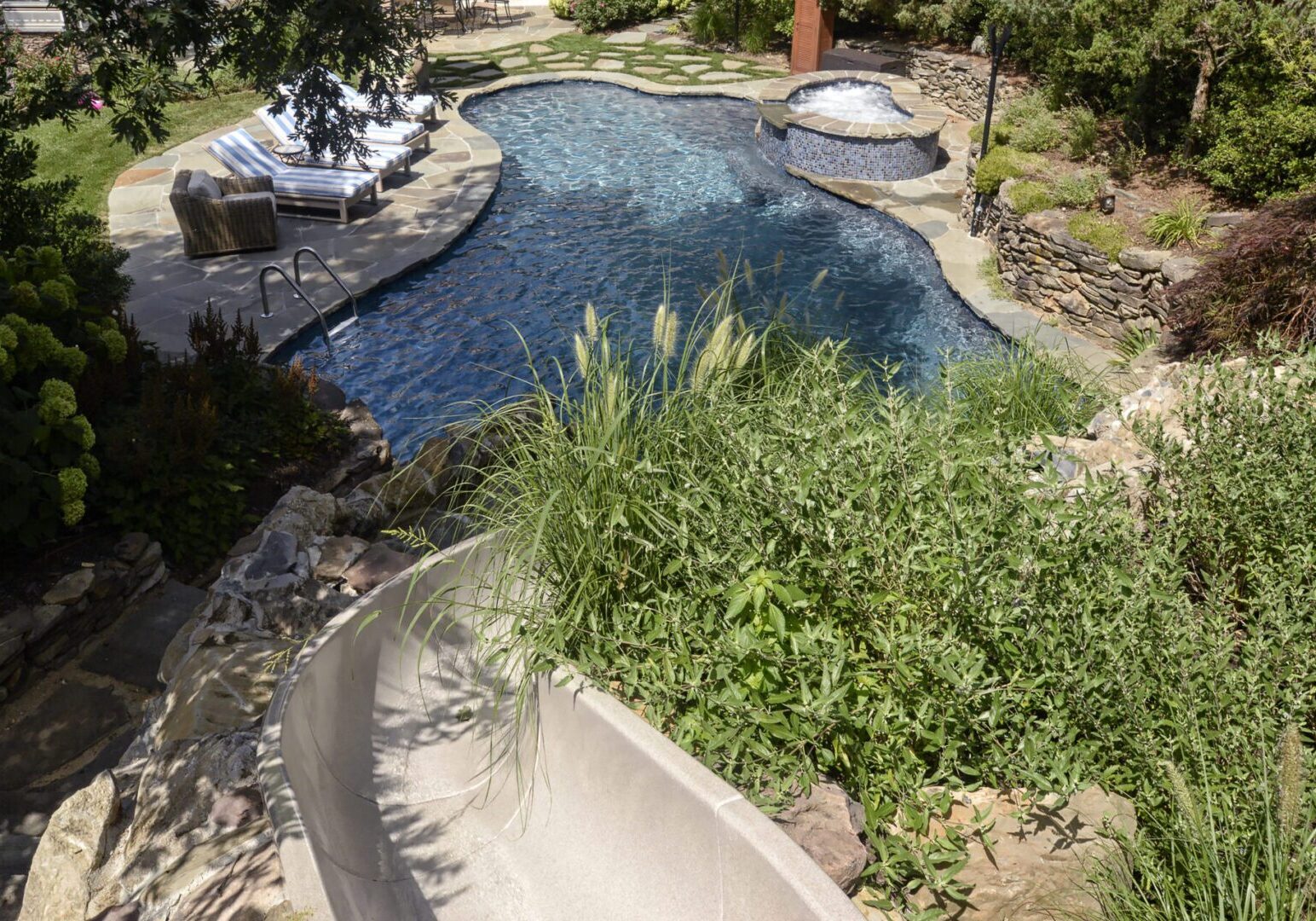 Lush garden surrounding outdoor pool area