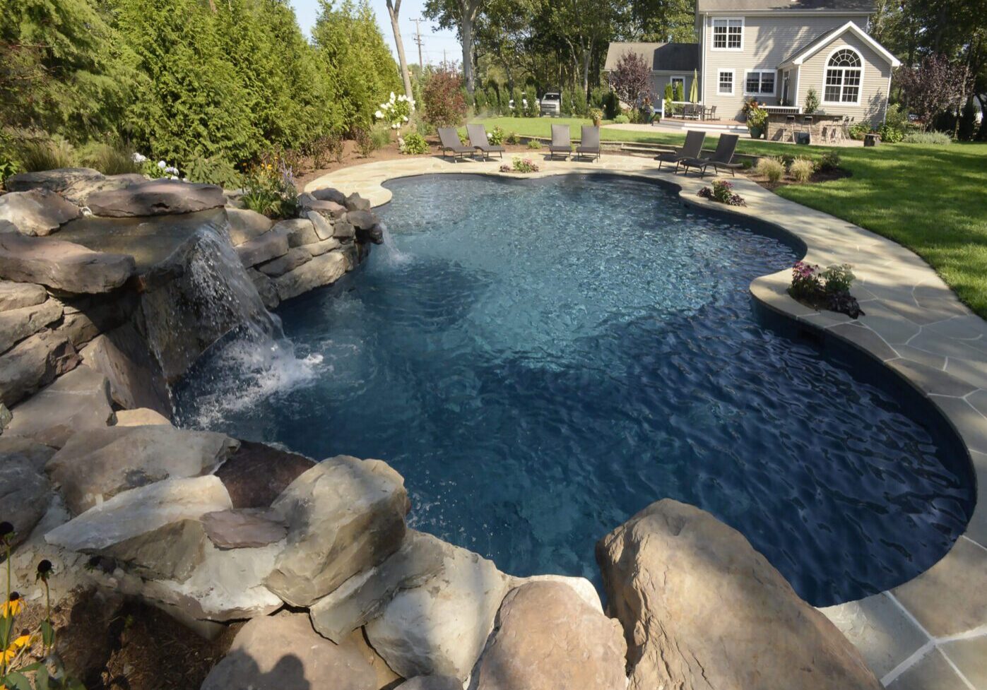 Serene poolside with stone waterfall