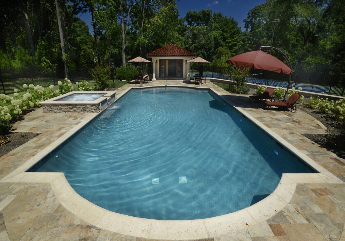 Luxury backyard pool with lounge chairs