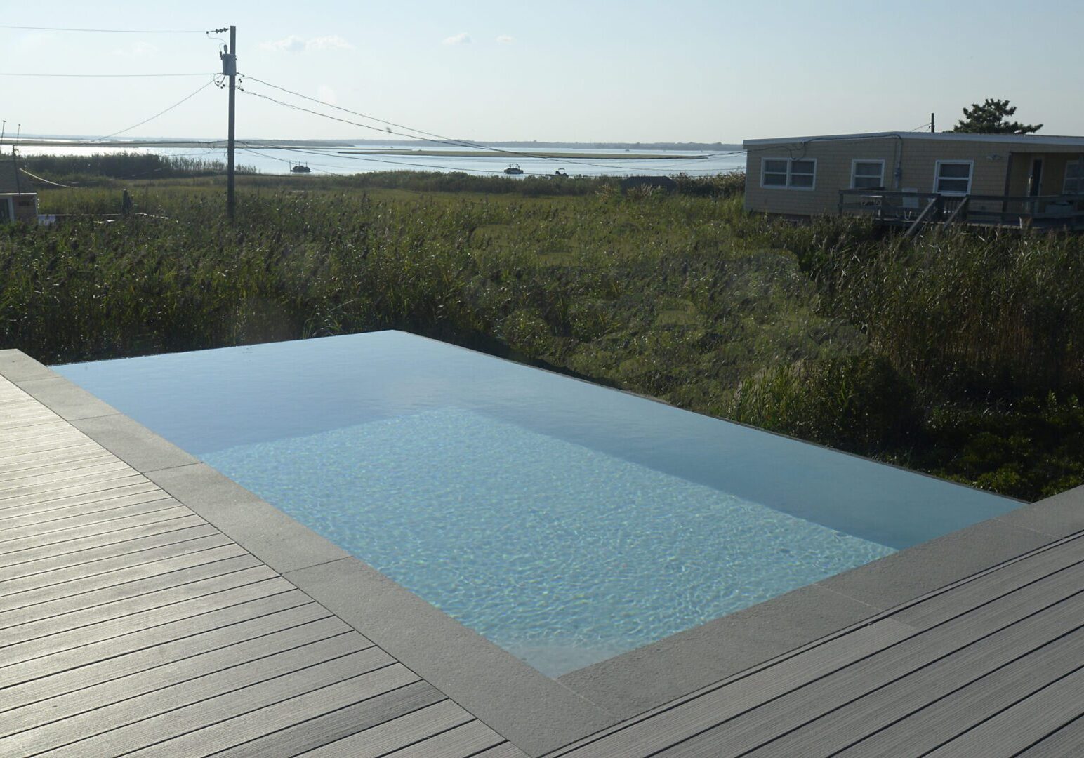 Pool beside grassy field and house