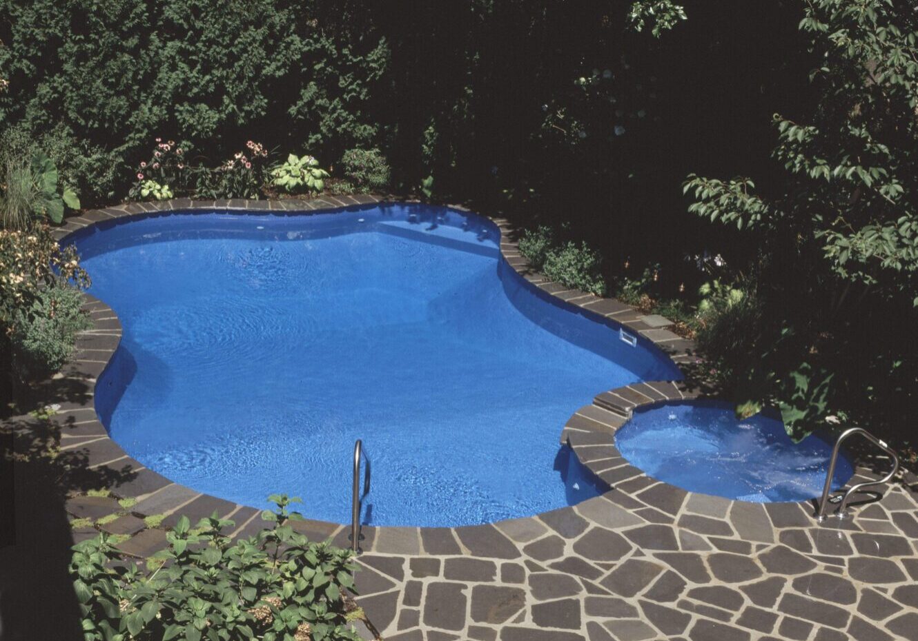 Backyard pool with stone patio