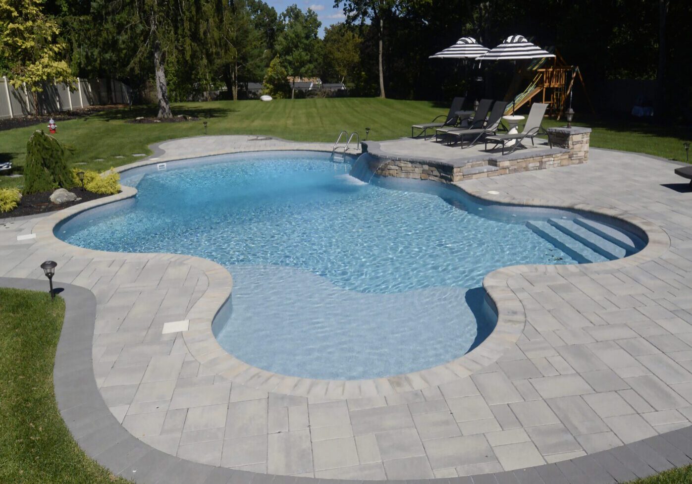 Modern swimming pool with sun loungers