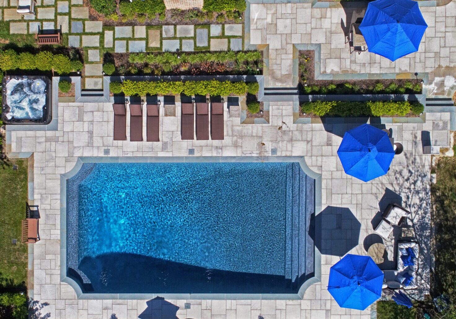 Aerial view of pool with blue umbrellas