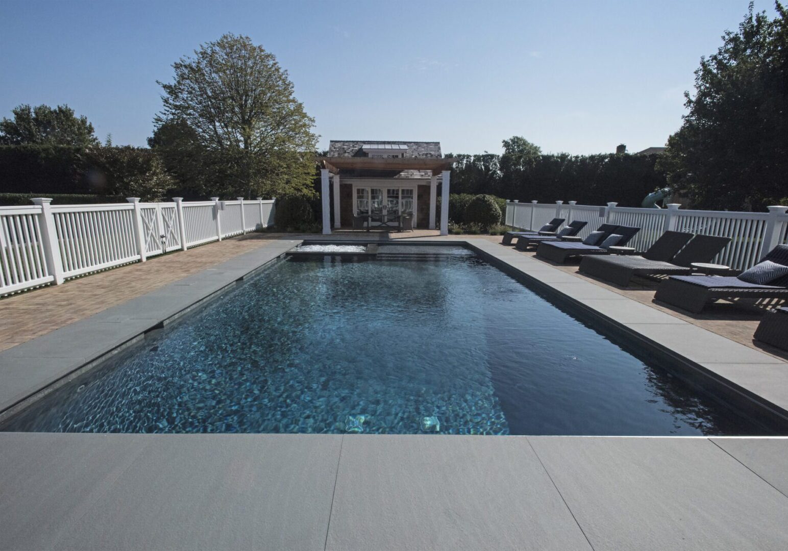 Serene poolside with white fencing