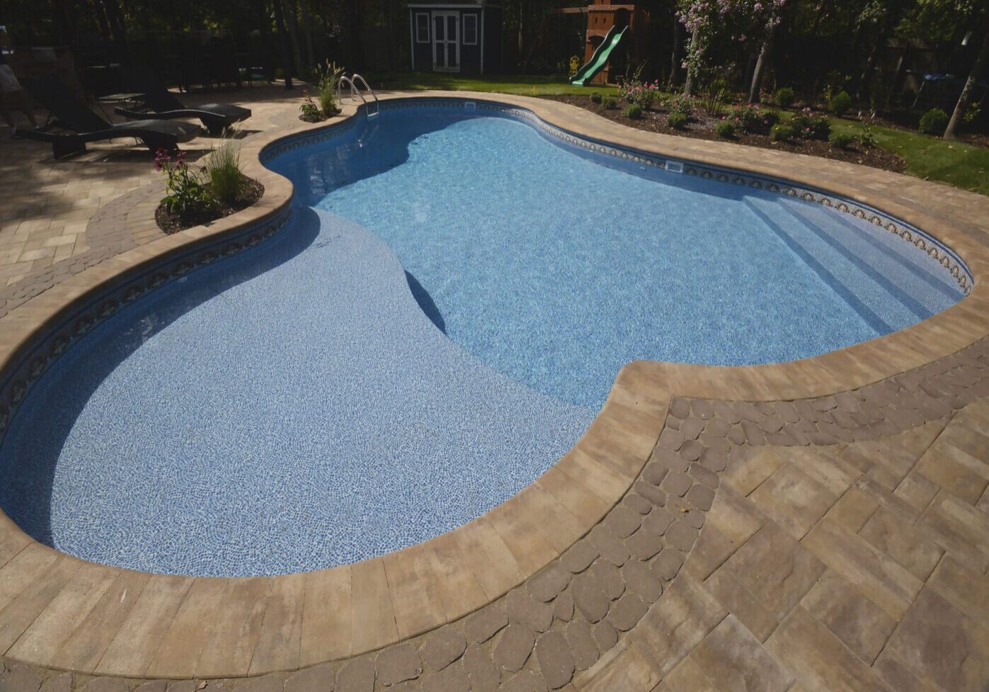 Kidney-shaped pool with clear blue water